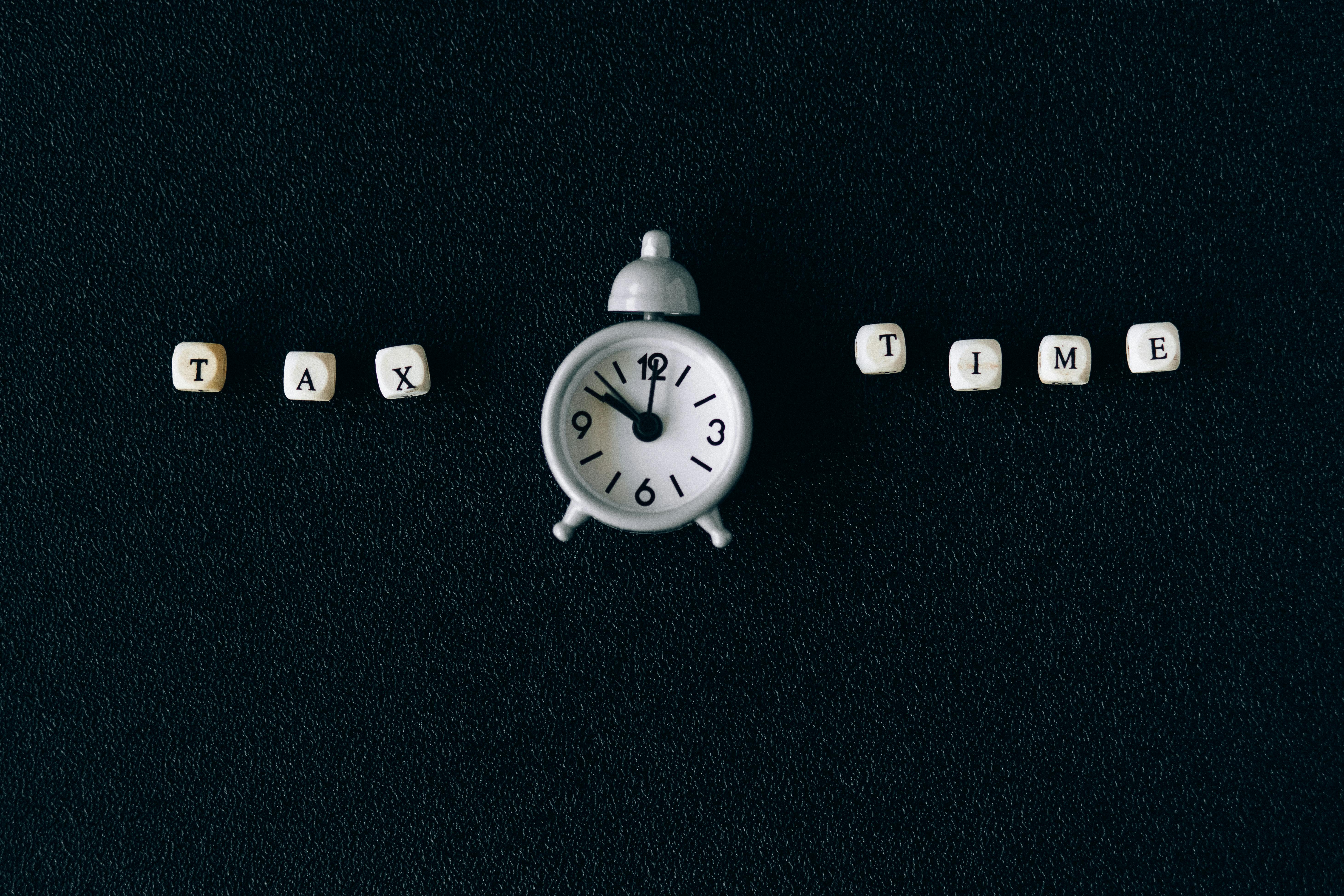 Tax Time Written on Dice Around an Alarm Clock